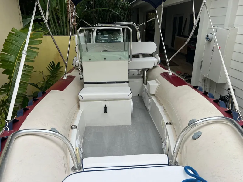 Slide: The Image of Novurania DL 550 2003 Hull boat interior, featuring seating and steering console, 2016 model. - 7