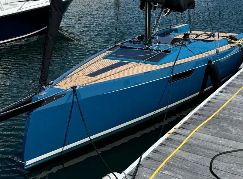 Slide: The Image of 2023 Saffier 24 Lite sailboat docked, featuring sleek blue design and wooden deck. - 5