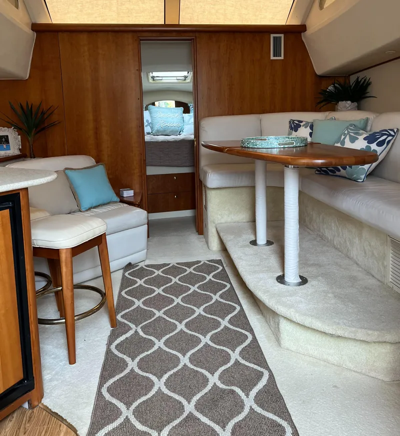 Slide: The Image of Interior of 1999 Silverton 330 Sport Bridge with cozy seating and modern decor. - 10