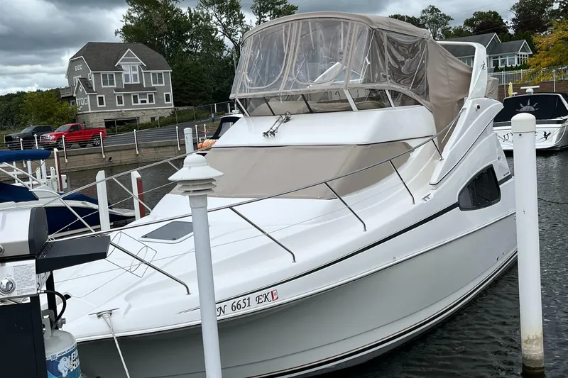 Slide: The Image of 1999 Silverton 330 Sport Bridge yacht docked at marina. - 14