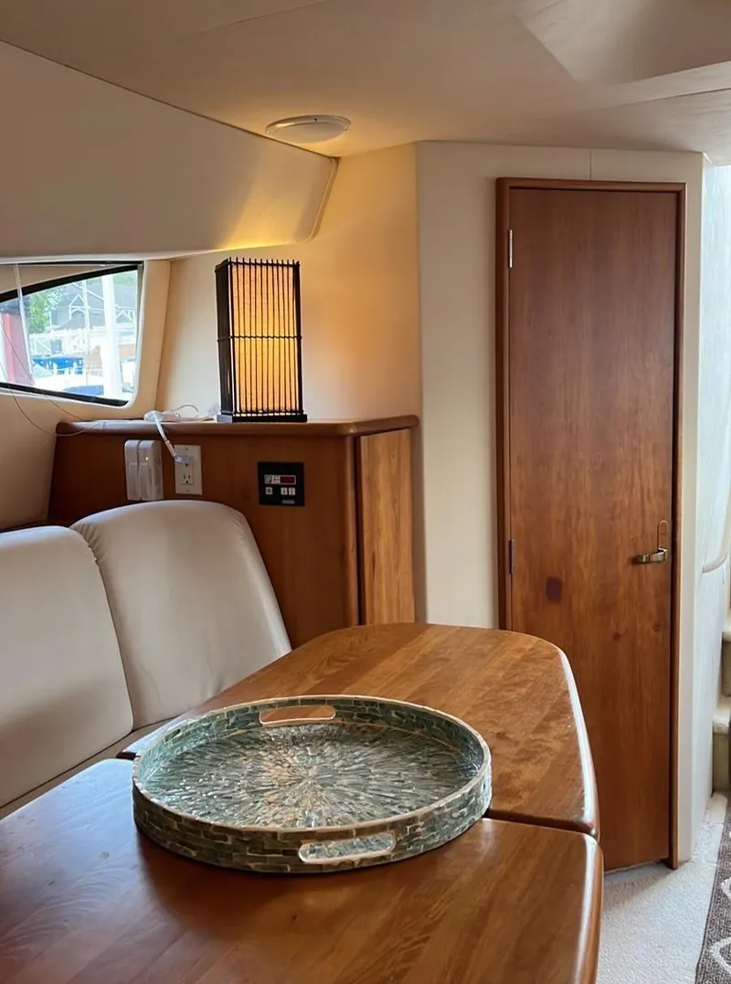 Slide: The Image of Interior of 1999 Silverton 330 Sport Bridge with wooden table and modern decor. - 18