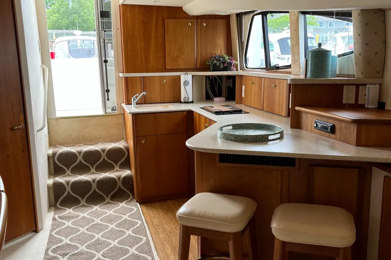 Slide: The Image of Interior of 1999 Silverton 330 Sport Bridge yacht with modern kitchen and seating area. - 21