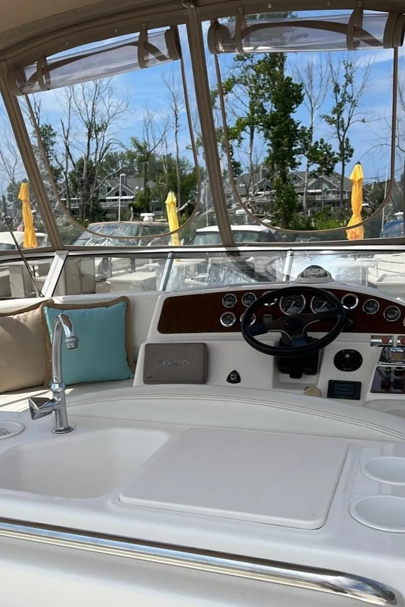 Slide: The Image of 1999 Silverton 330 Sport Bridge yacht cockpit with steering wheel and dashboard. - 25