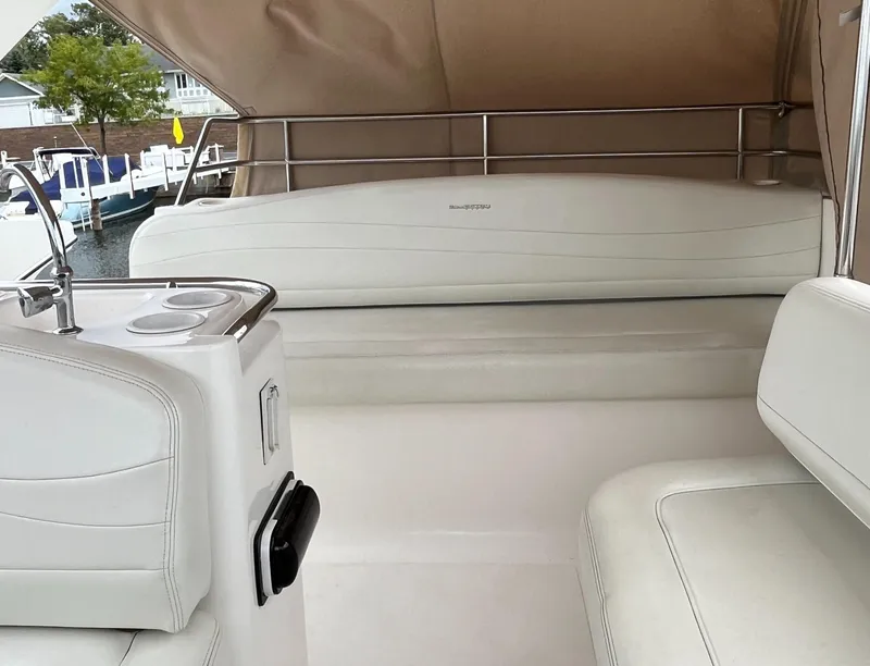 Slide: The Image of 1999 Silverton 330 Sport Bridge interior with white seating and railing. - 6