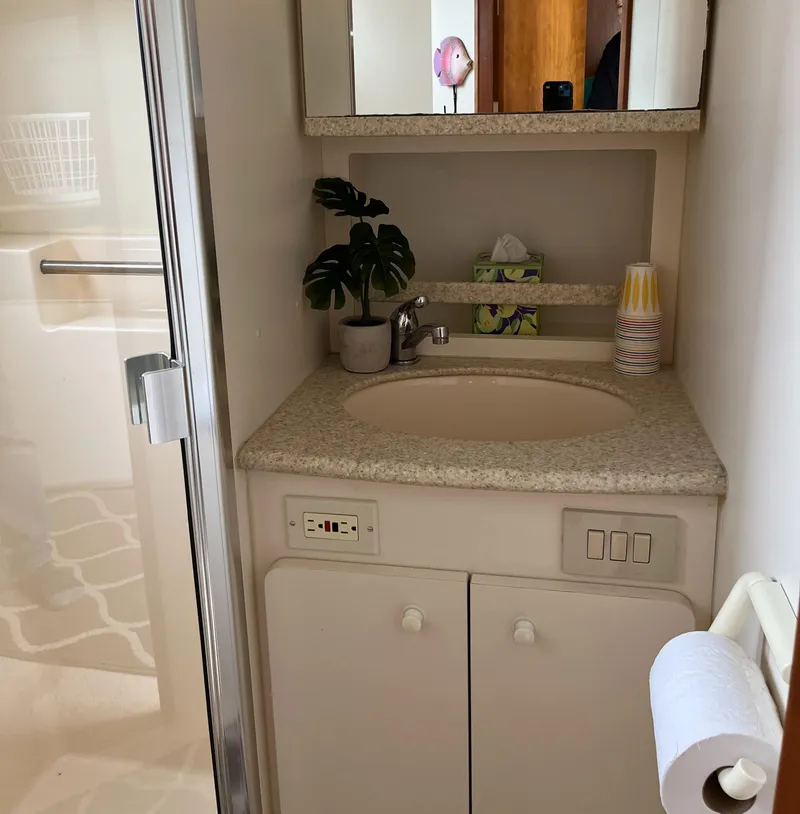 Slide: The Image of 1999 Silverton 330 Sport Bridge bathroom with sink, mirror, and shower. - 7
