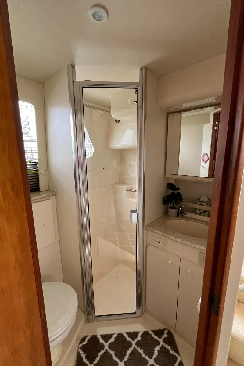 Slide: The Image of 1999 Silverton 330 Sport Bridge bathroom with shower, sink, and toilet. - 8
