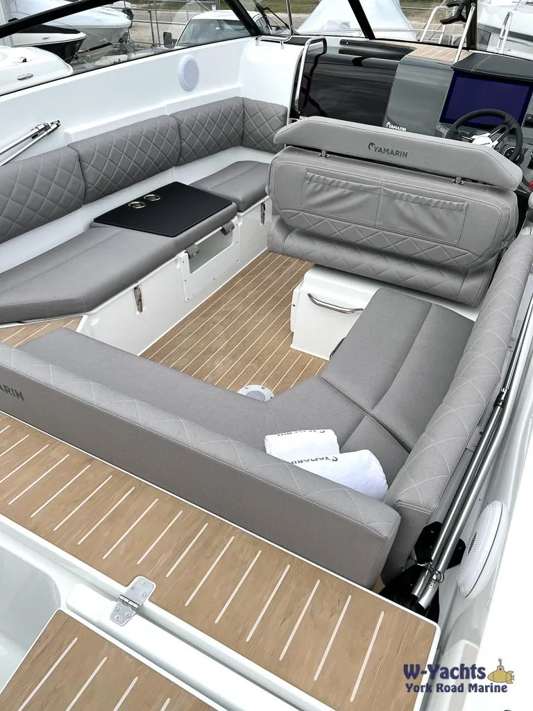 Slide: The Image of 2024 Yamarin 67 DC boat interior with gray seating and wooden flooring. - 16
