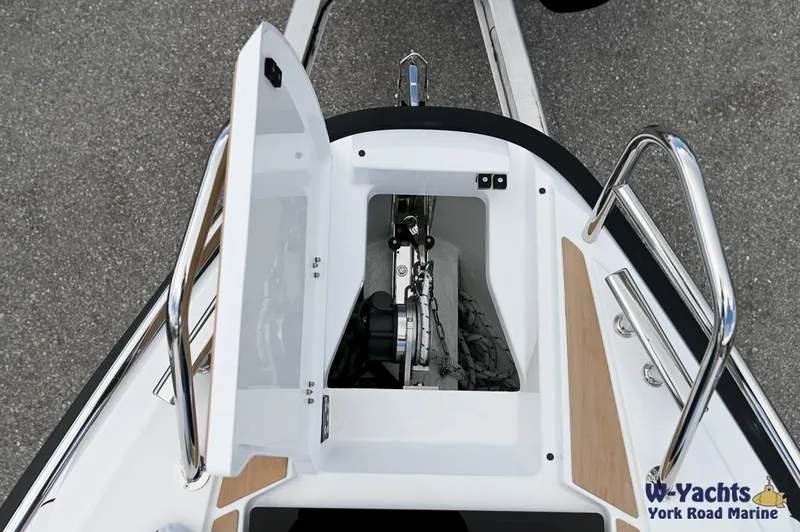 Slide: The Image of 2024 Yamarin 67 DC boat anchor compartment with open hatch, showcasing chain and storage. - 18