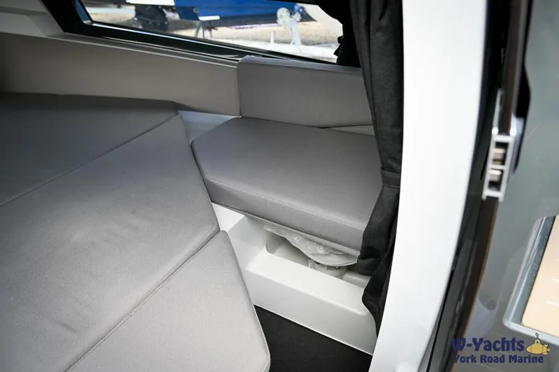 Slide: The Image of 2024 Yamarin 67 DC cabin interior with gray seating and cushions. - 20