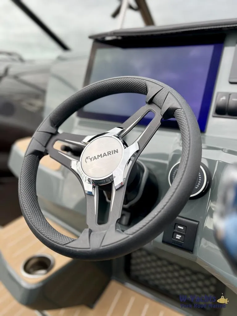 Slide: The Image of Steering wheel of 2024 Yamarin 67 DC boat with modern dashboard display. - 21