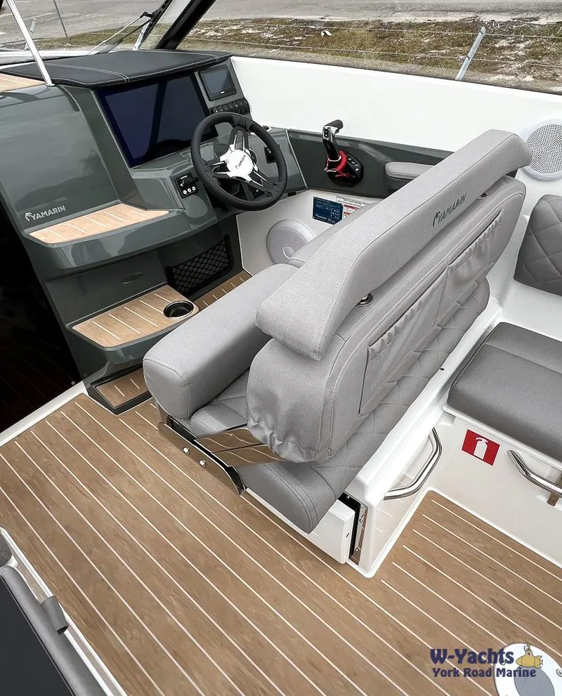 Slide: The Image of 2024 Yamarin 67 DC boat interior with modern dashboard and comfortable seating. - 7