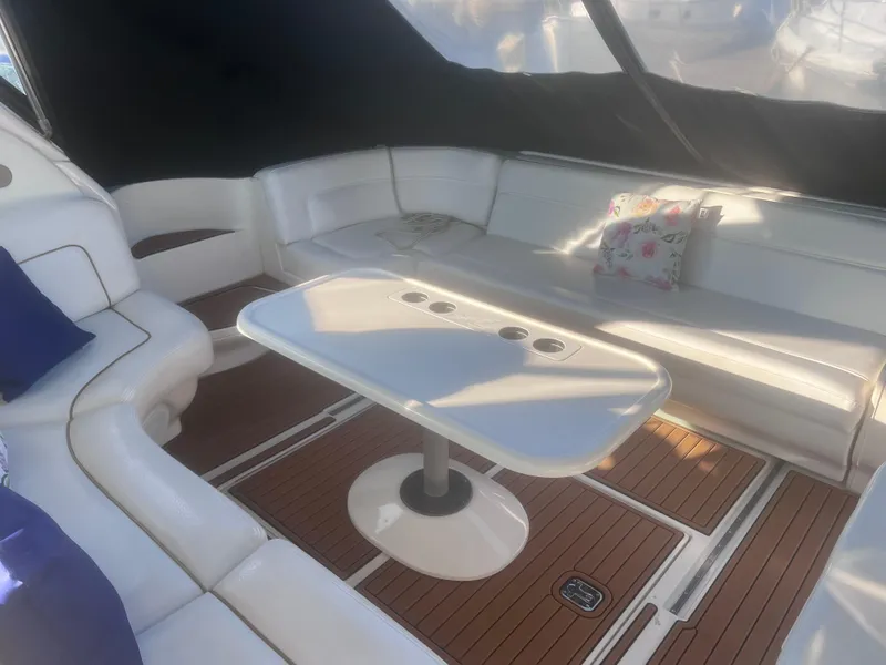 Slide: The Image of 2000 Sea Ray 460 Sundancer boat deck with brown flooring and white cabinetry. - 16
