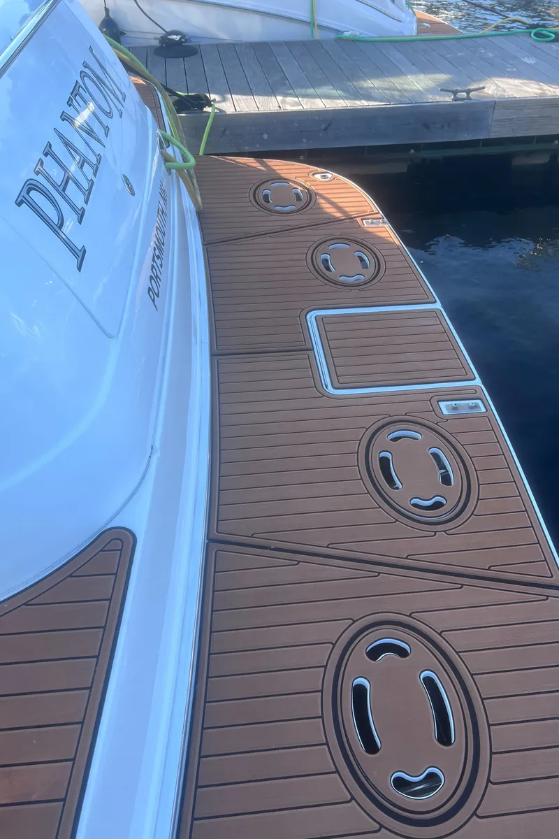 Slide: The Image of Luxurious interior of 2000 Sea Ray 460 Sundancer yacht with white seating and table. - 17