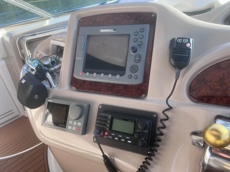Slide: The Image of Helm of 2000 Sea Ray 460 Sundancer yacht with wooden steering wheel and navigation equipment. - 22