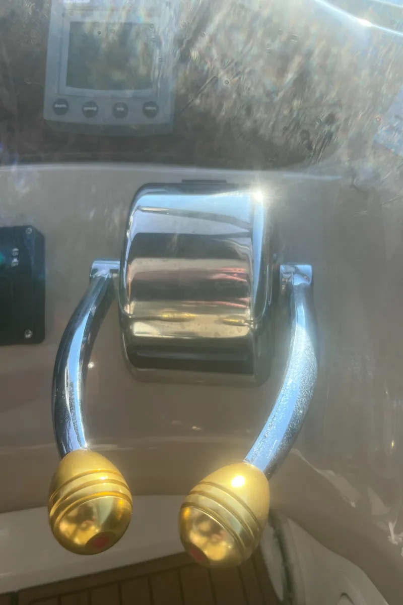 Slide: The Image of Dashboard of a 2000 Sea Ray 460 Sundancer boat with multiple gauges. - 26