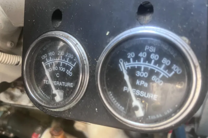Slide: The Image of Close-up of Sea Ray 460 Sundancer 2000 generator gauges and engine hours display. - 30