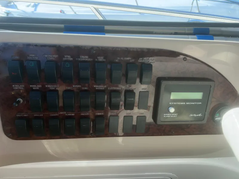 Slide: The Image of Control panel of a 2000 Sea Ray 460 Sundancer yacht with various switches and gauges. - 32