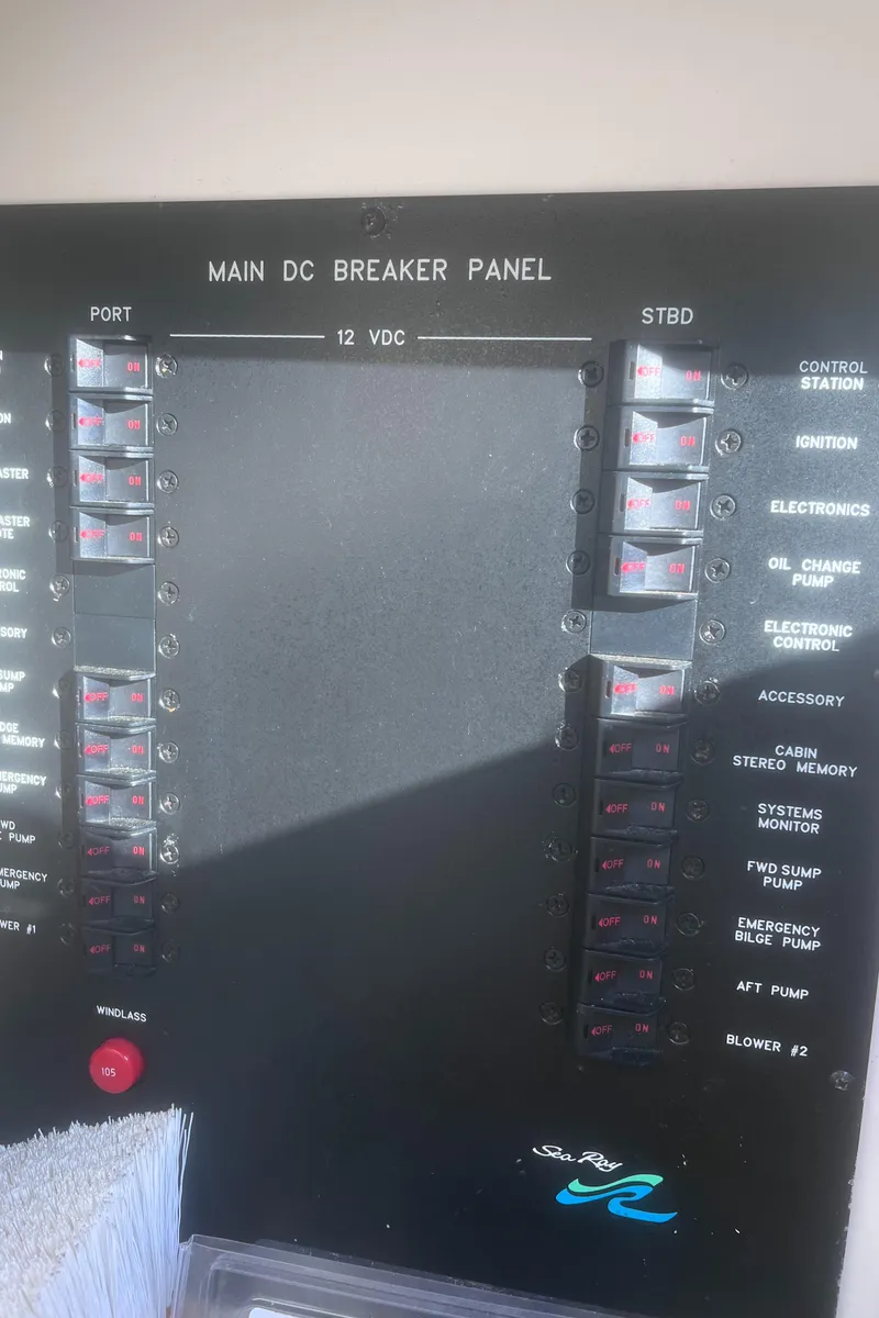 Slide: The Image of Control panel of a 2000 Sea Ray 460 Sundancer boat with switches and display. - 33