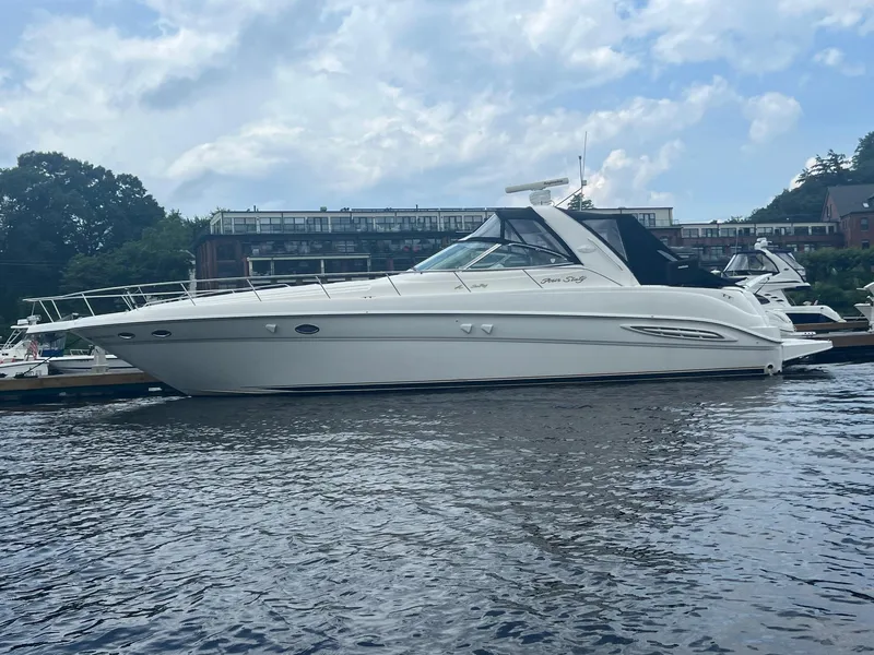 Slide: The Image of 2000 Sea Ray 460 Sundancer yacht docked at sunset, calm waters. - 4