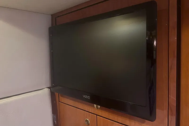 Slide: The Image of Interior of 2000 Sea Ray 460 Sundancer yacht with plush seating and nautical decor. - 45