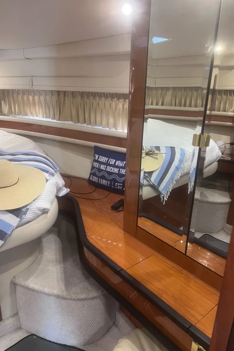 Slide: The Image of Interior of 2000 Sea Ray 460 Sundancer yacht with bed, mirror, and seating area. - 50