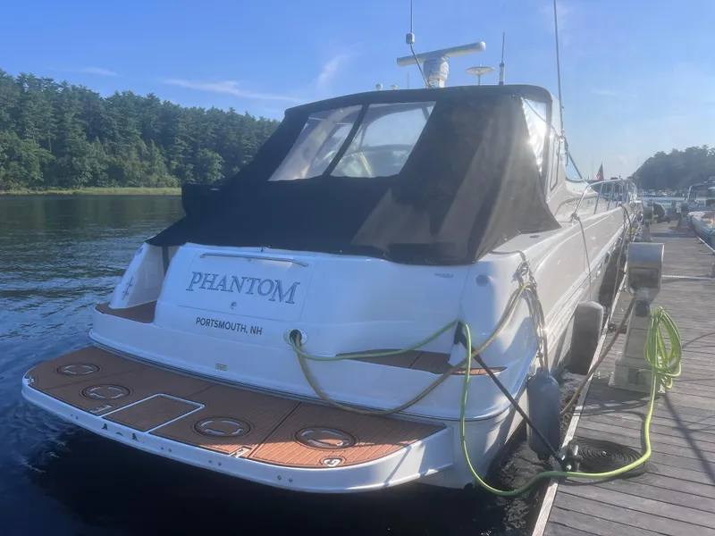 Slide: The Image of 2000 Sea Ray 460 Sundancer yacht on calm water, rear view. - 6