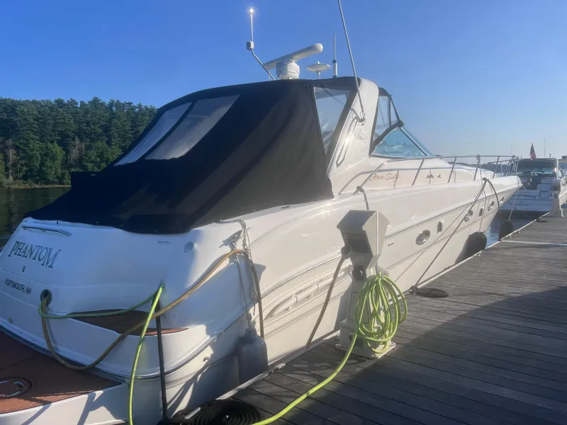 Slide: The Image of 2000 Sea Ray 460 Sundancer docked, rear view with black canopy, labeled "Phantom." - 7