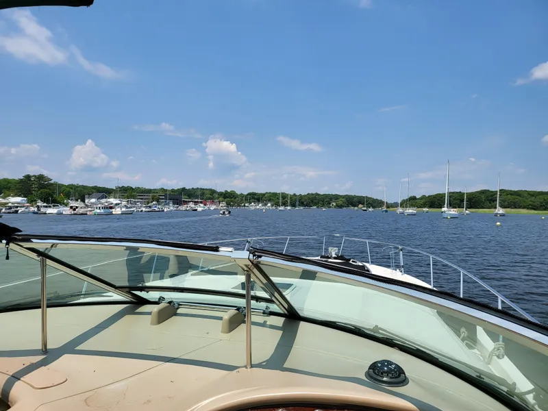 Slide: The Image of Bow view of 2000 Sea Ray 460 Sundancer yacht cruising on calm ocean under clear blue sky. - 9