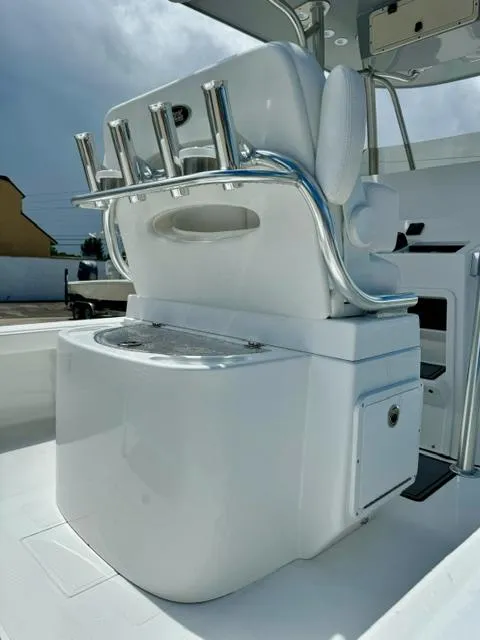 Slide: The Image of 2025 BlackJack 256 Coastal boat interior with rod holders and storage. - 12