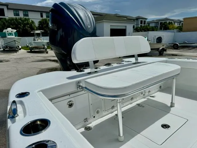Slide: The Image of 2025 BlackJack 256 Coastal boat with white seating and Yamaha engine in a marina setting. - 13