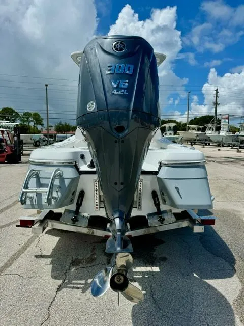 Slide: The Image of 2025 BlackJack 256 Coastal boat with Yamaha 300 V6 engine, parked outdoors. - 3