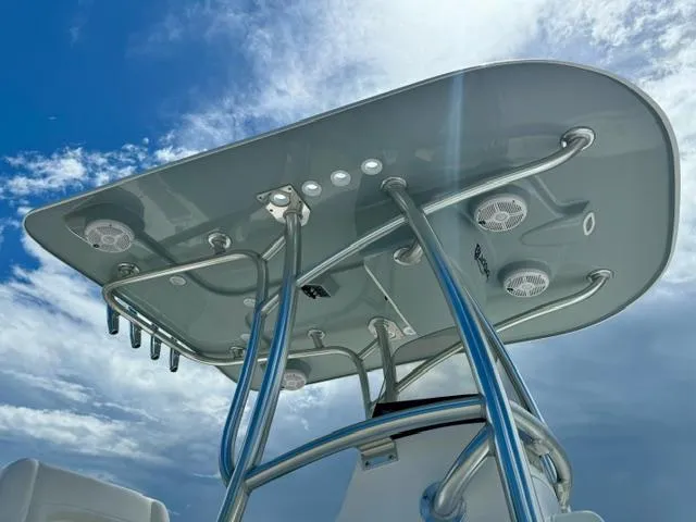 Slide: The Image of BlackJack 256 Coastal 2025 boat T-top against blue sky with clouds. - 9