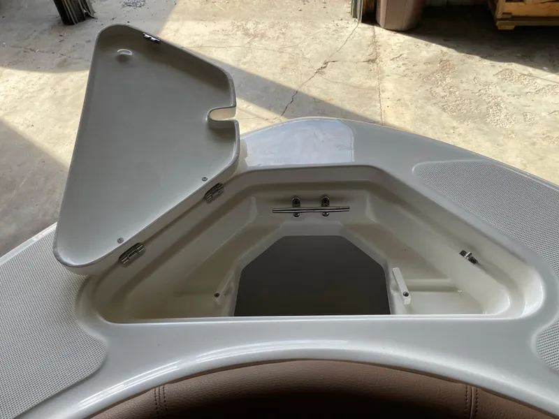 Slide: The Image of 2024 Pioneer 202 Islander boat storage compartment with open lid, showcasing interior space. - 4