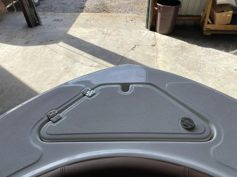 Slide: The Image of 2024 Pioneer 202 Islander boat deck with storage compartment and latch. - 5