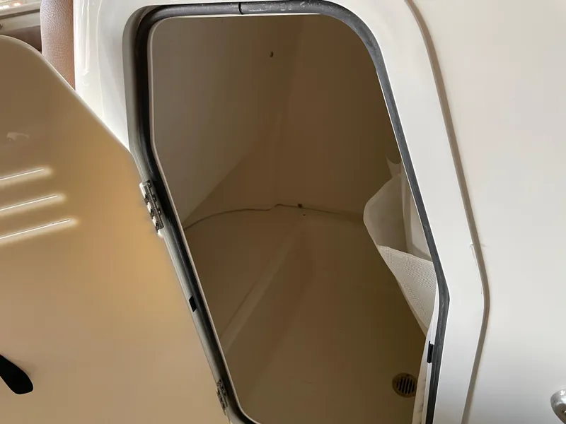 Slide: The Image of 2024 Pioneer 202 Islander boat storage compartment with open hatch. - 9