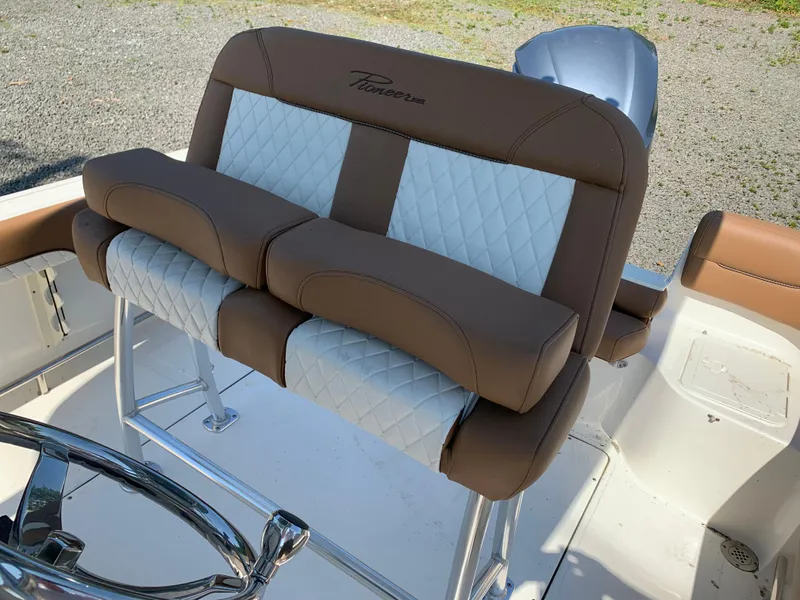 Slide: The Image of 2024 Pioneer 222 Islander boat seat with brown and white upholstery, featuring a stylish design. - 19