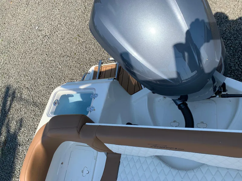 Slide: The Image of 2024 Pioneer 222 Islander boat with outboard motor and cushioned seating. - 22