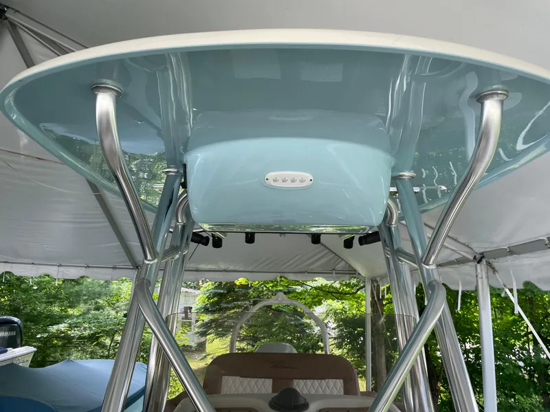 Slide: The Image of 2024 Pioneer 222 Islander boat with sleek T-top and stainless steel supports. - 24