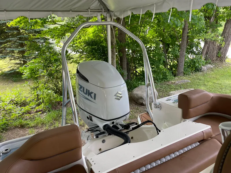 Slide: The Image of 2024 Pioneer 222 Islander boat with Suzuki outboard motor, surrounded by lush greenery. - 28