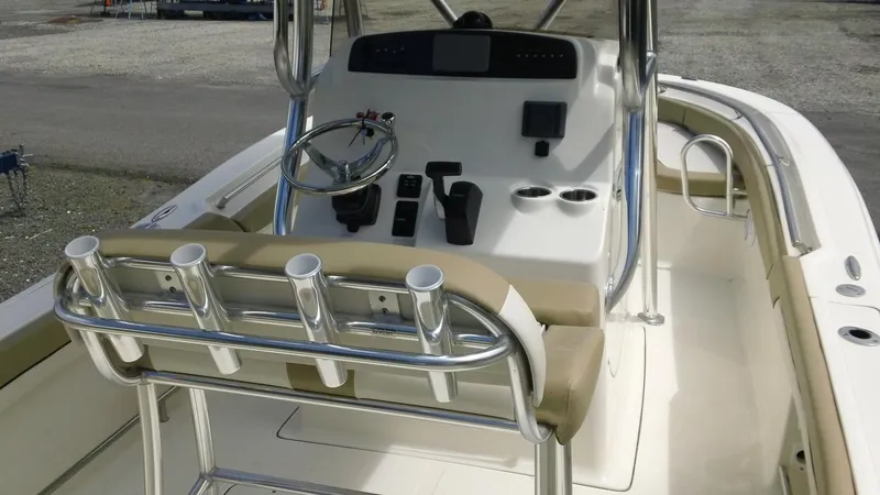 Slide: The Image of 2024 Pioneer 222 Islander boat interior with steering console and rod holders. - 5