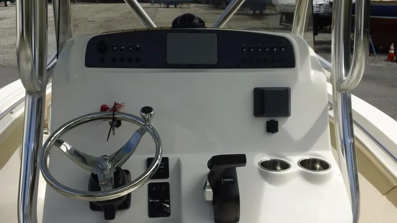Slide: The Image of 2024 Pioneer 222 Islander boat dashboard with steering wheel and controls. - 6