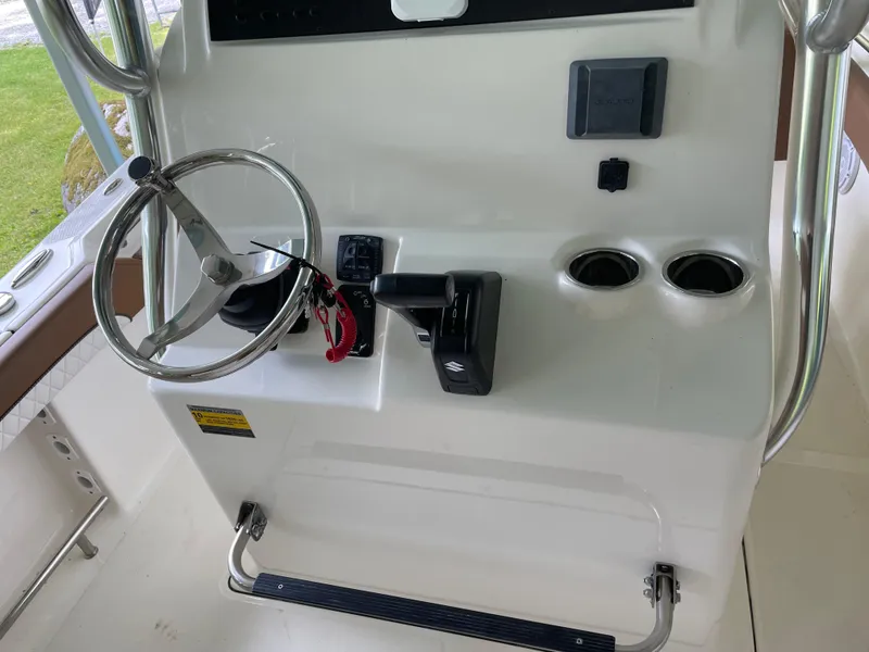 Slide: The Image of 2024 Pioneer 222 Islander boat console with steering wheel and controls. - 8
