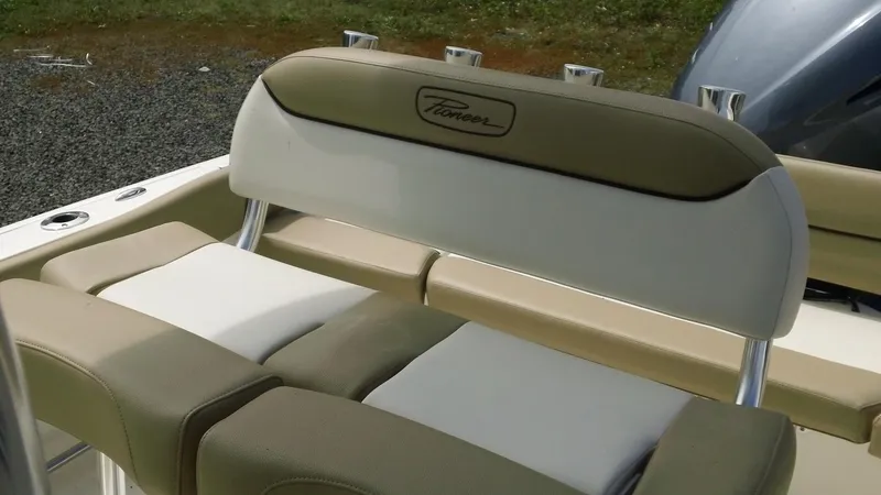 Slide: The Image of 2024 Pioneer 222 Islander boat seating with beige and white upholstery. - 9