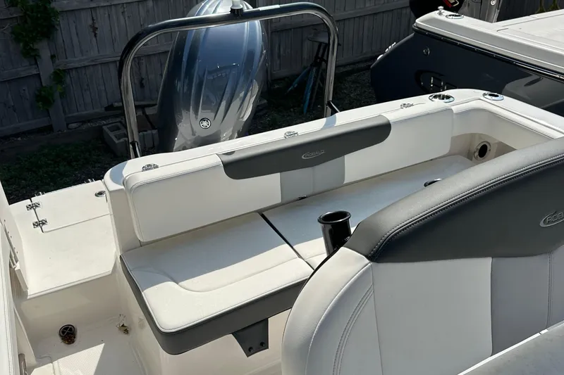 Slide: The Image of 2025 Robalo R222 Explorer boat interior with white seating and cup holder. - 9