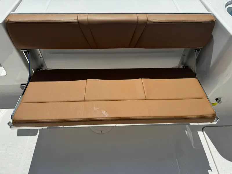 Slide: The Image of 2025 Robalo R250 Center Console boat with brown cushioned seating. - 15