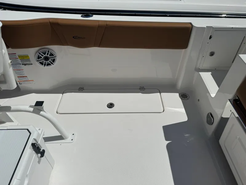 Slide: The Image of 2025 Robalo R250 Center Console boat interior with storage compartment and speaker. - 16