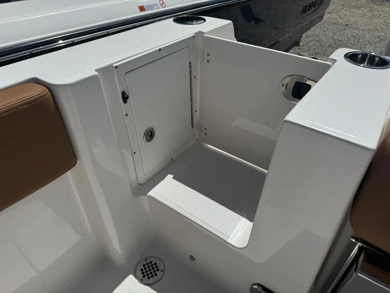 Slide: The Image of 2025 Robalo R250 Center Console boat interior with storage compartment and seating. - 17