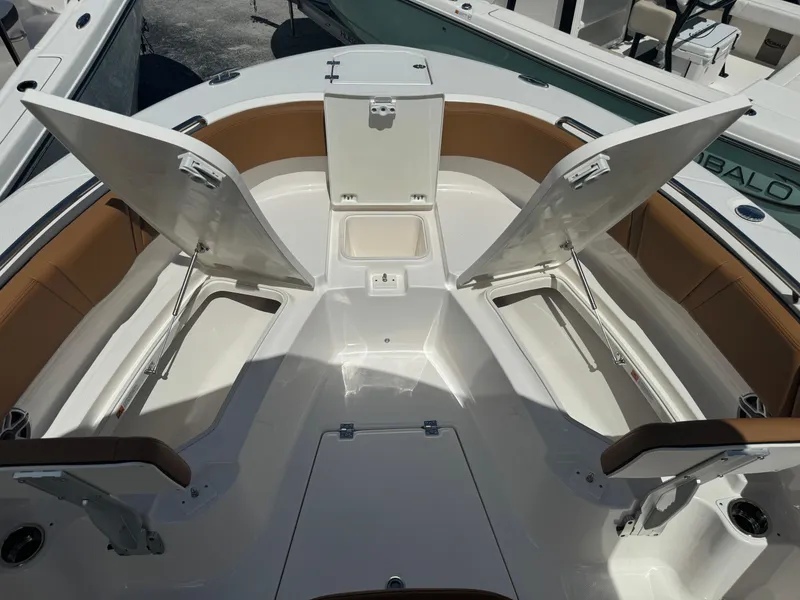 Slide: The Image of 2025 Robalo R250 Center Console boat interior with open storage compartments. - 19