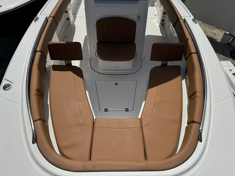 Slide: The Image of 2025 Robalo R250 Center Console boat with tan cushioned seating. - 21