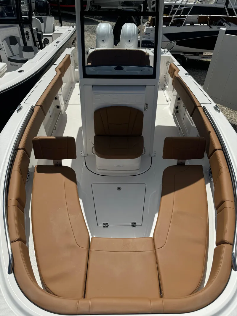 Slide: The Image of 2025 Robalo R250 Center Console boat with tan seating and sleek design. - 22